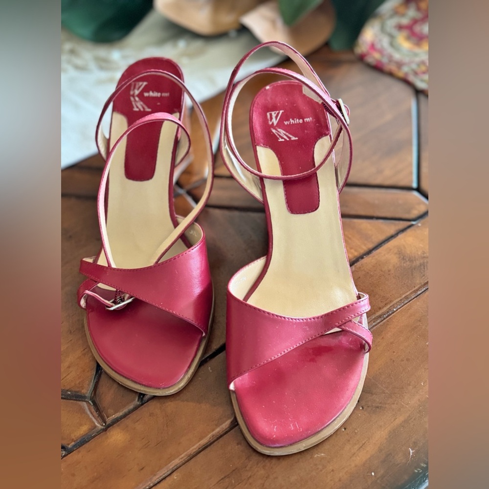Casual leather sandals with a wedge heel and ankle strap.